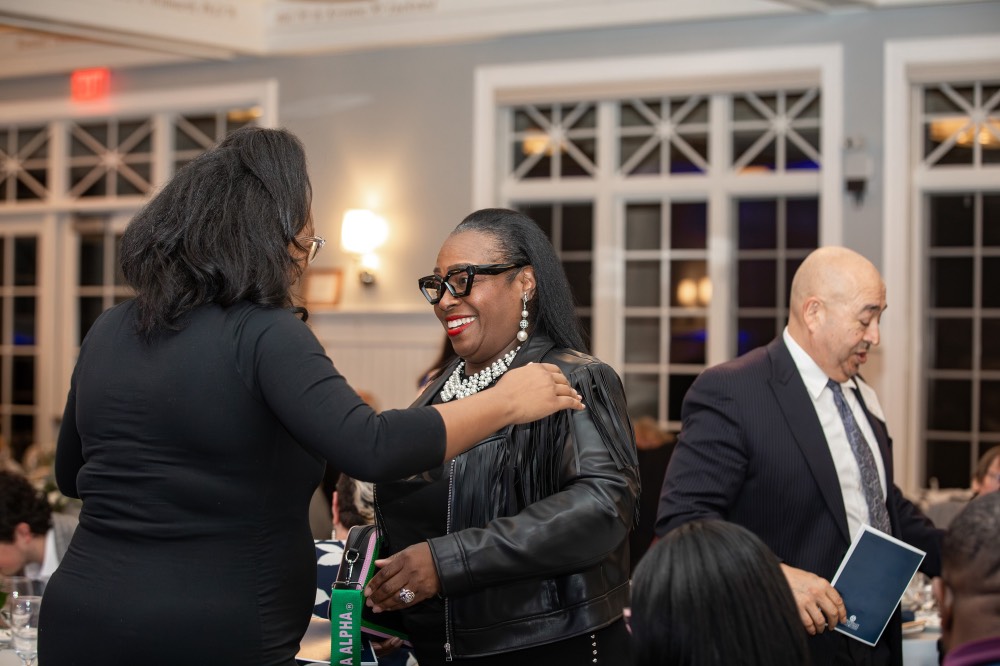 Woman putting her hand on another woman's shoulder